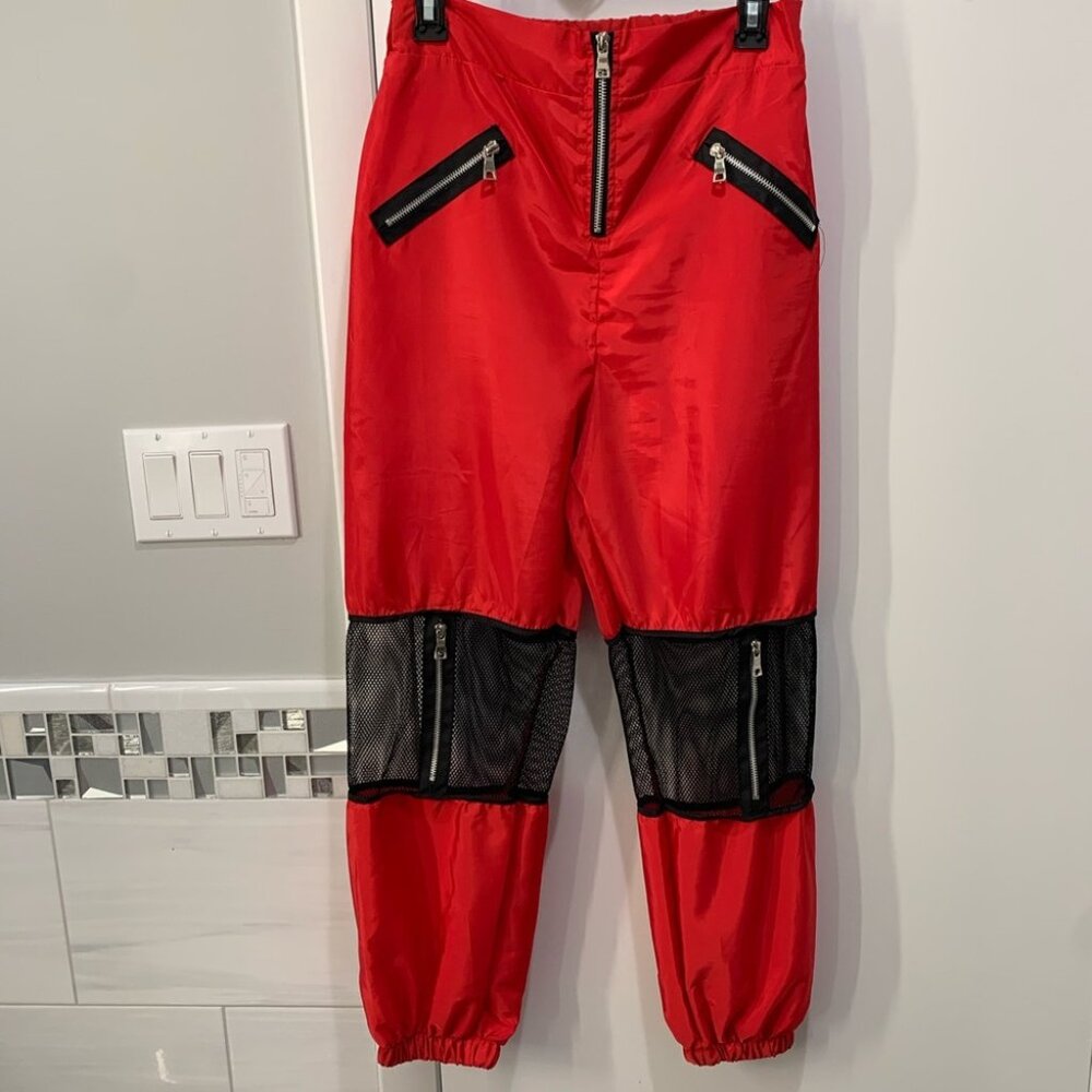 Red joggers with fishnet cutouts